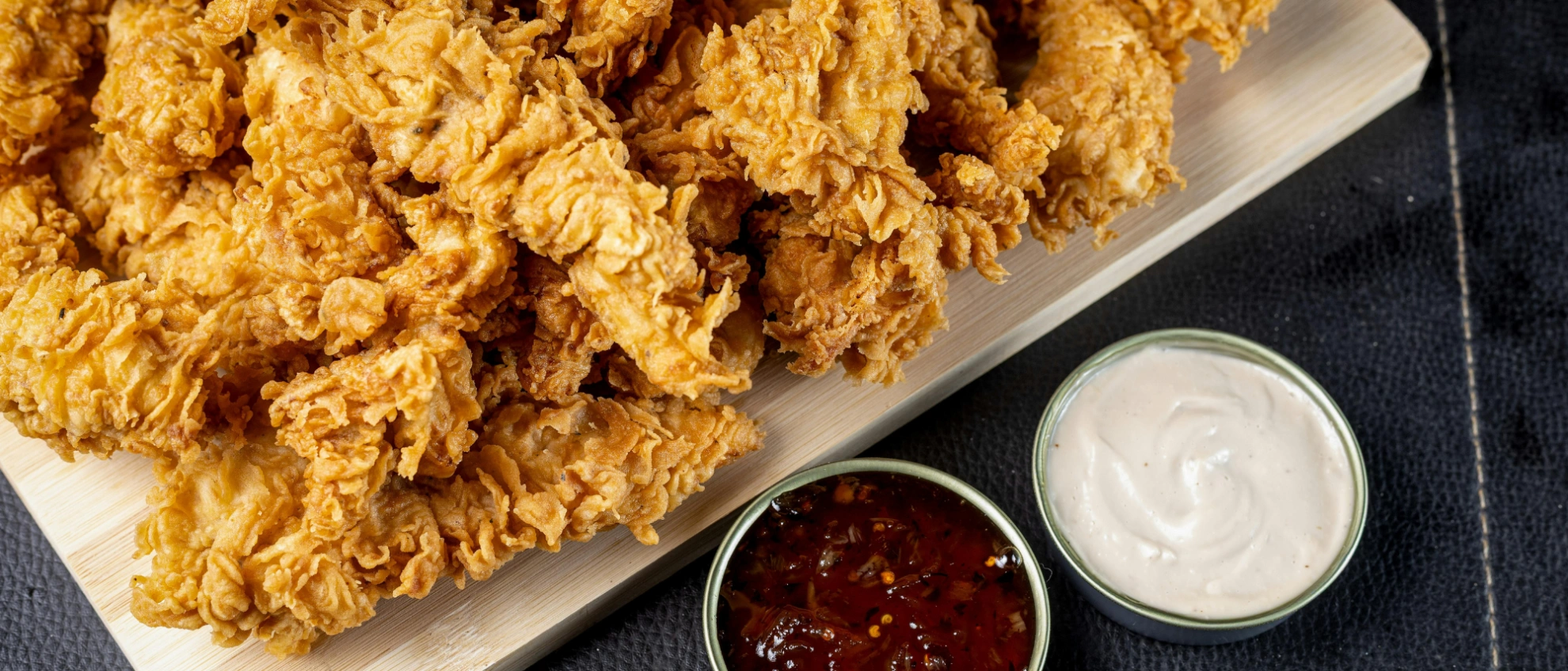 Frittierte Hähnchenstücke mit Dips Knusprige Hähnchenteile mit Dip, typisches Gericht großer Franchise-Ketten