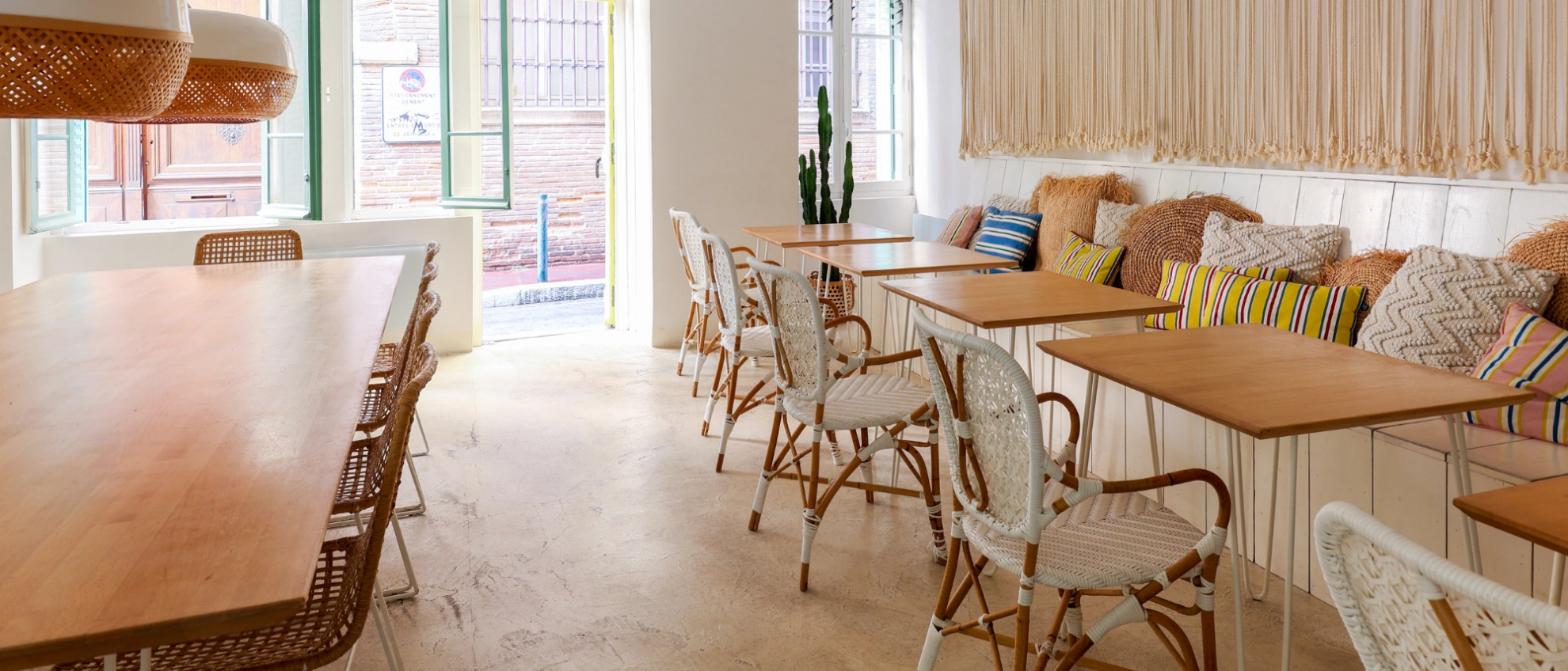 Modern eingerichteter Gastraum mit Sitzecke, Holztischen und kindgerechtem Ambiente